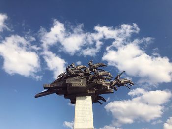 Low angle view of statue against cloudy sky