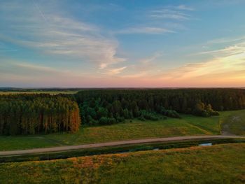 Scenic view of land against sky during sunset