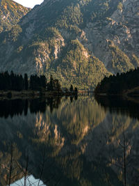 Scenic view of lake in forest against sky reflection 