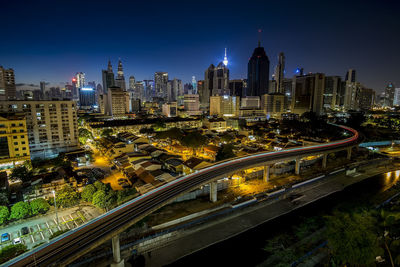 High angle view of city lit up at night