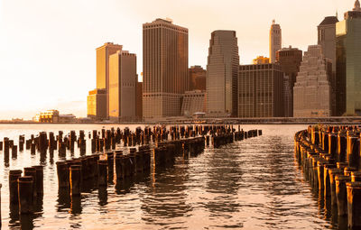 Lower manhattan at sunset with wooden piers in the foreground