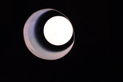 Close-up of illuminated lamp against black background