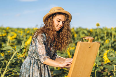 Young woman standing on field