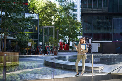 Rear view of young woman standing in park