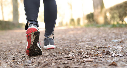 Low section of woman walking outdoors