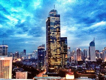 Skyscrapers against cloudy sky