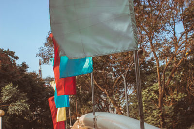 Low angle view of flags hanging from tree