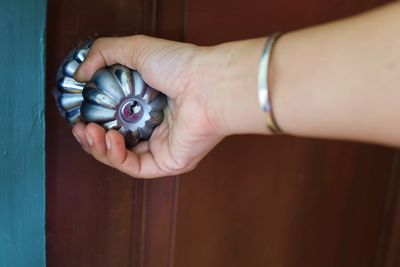 Cropped image of woman hand holding doorknob