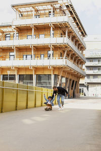 Girl on skateboard with father