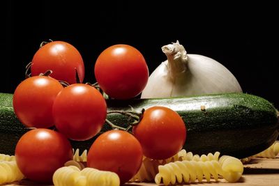 Close-up of tomatoes over black background