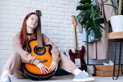 Portrait of woman playing guitar