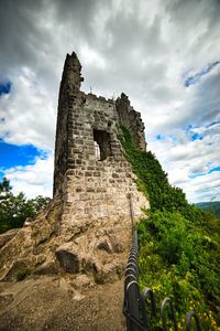 Low angle view of historical building against cloudy sky