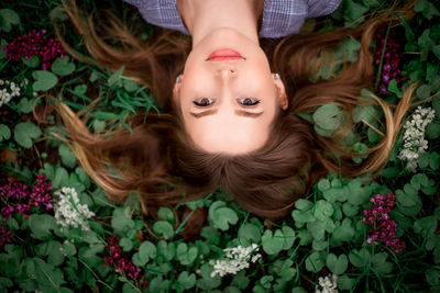 High angle view of woman lying down on plant