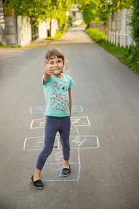 Portrait of young woman walking on road