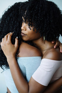 Portrait of two women of color hugging each other