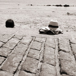 Clothing and hat on retaining wall at beach