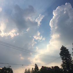 Low angle view of silhouette trees against sky