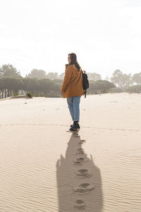 Footprints of young woman while walking on beach