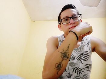 Portrait of mid adult woman standing against wall at home