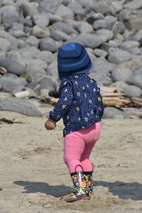 Rear view of girl on rock