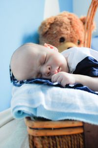 Close-up of cute baby sleeping on bed at home