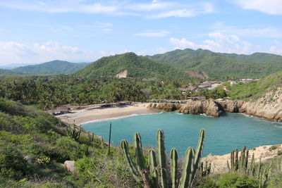 Scenic view of sea and mountains against sky