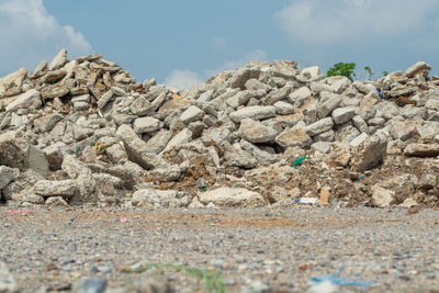 Low angle view of rocks on land against sky