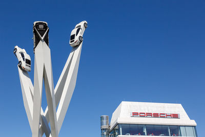 Low angle view of sign against clear blue sky