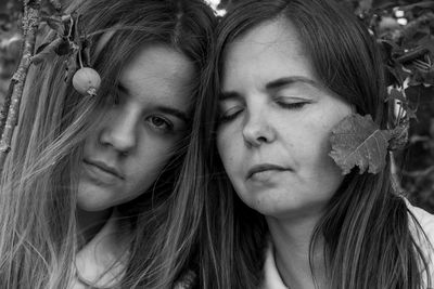 Close-up portrait of woman with mother outdoors