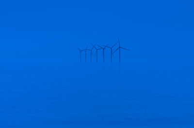 Offshore wind turbines generating renewable electricity and energy  background image