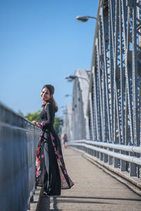 Beautiful woman walking over truong tien bridge in hue / vietnam