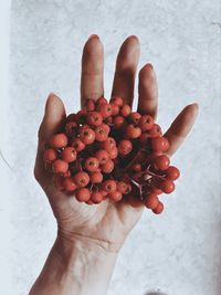 Close-up of hand holding strawberry