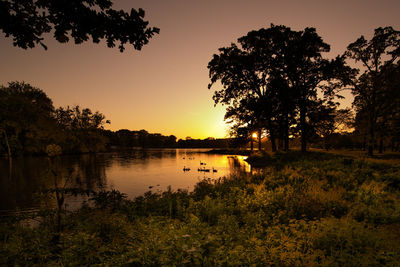 Scenic view of lake against sky during sunset