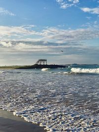 Scenic view of sea against cloudy sky