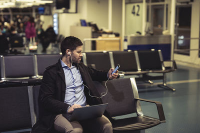 Man working with laptop at airport