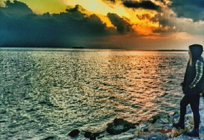 Scenic view of sea against cloudy sky