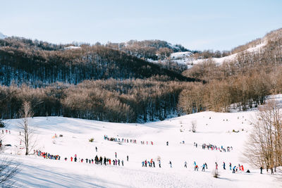 Group of people on snow covered landscape