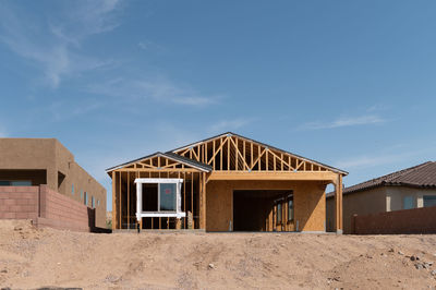 New home under construction with blue sky and copy space.