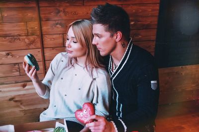 Young couple holding mobile phone