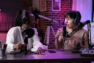 Females podcasting at studio