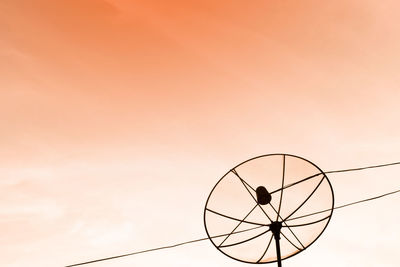 Silhouette ferris wheel against sky during sunset