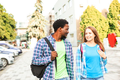 Young couple standing on street in city