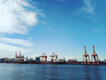 Commercial dock by sea against sky