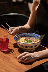 Midsection of woman preparing food on table