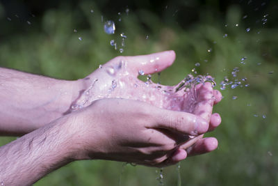 Close-up of hand splashing water