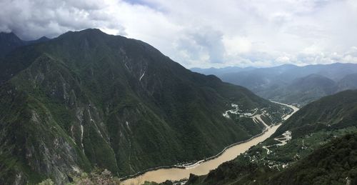 Scenic view of mountains against cloudy sky