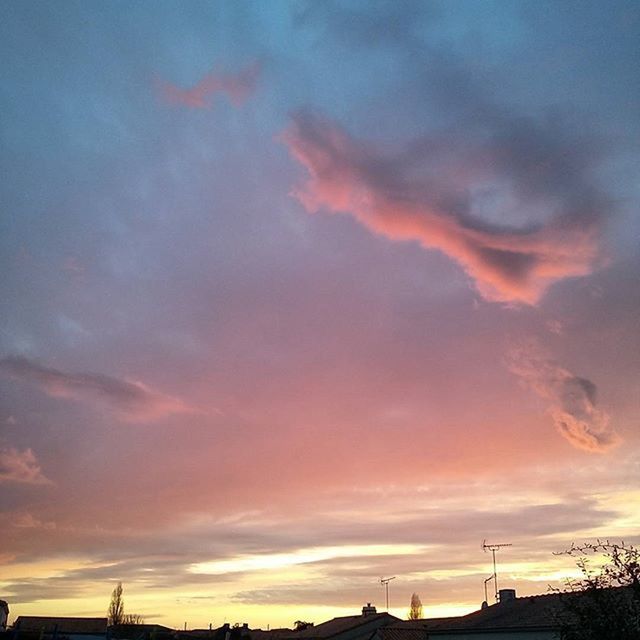 sunset, sky, cloud - sky, orange color, silhouette, beauty in nature, scenics, tranquility, low angle view, cloudy, dramatic sky, cloud, tranquil scene, nature, idyllic, built structure, moody sky, architecture, outdoors, building exterior