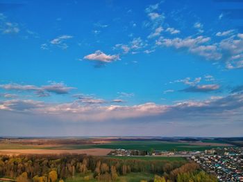 Scenic view of agricultural field against blue sky