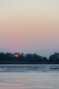 Scenic view of lake against sky during winter