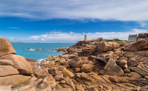 Rocks on beach against sky
